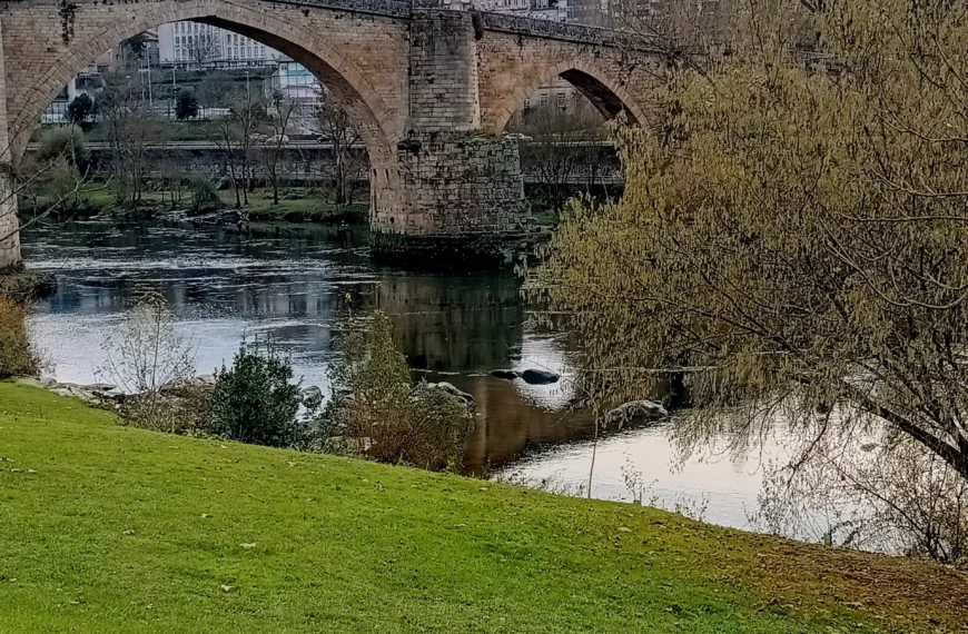 Historic stone bridge crossing a river in Ourense