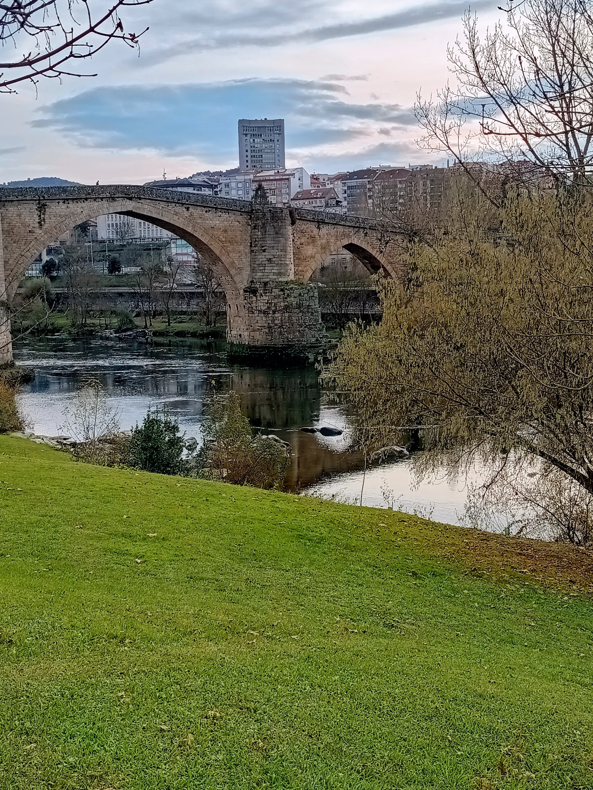 Historic stone bridge crossing a river in Ourense